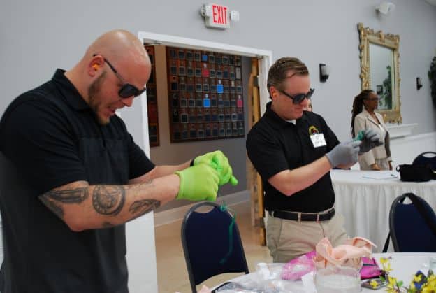 Class members Rob Vest and Pat Hickey participate in a dementia exercise during the Healthcare session on May 19, 2022.